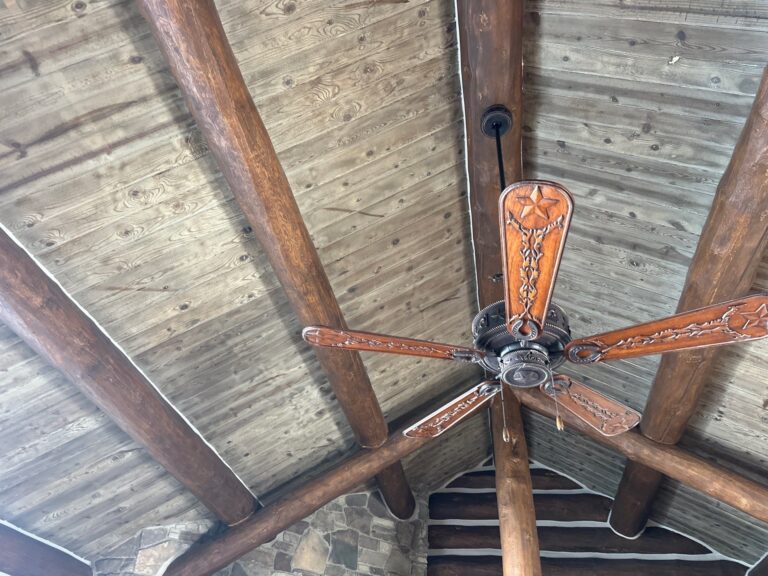 Hand-built twig handrail on a log home deck in Jackson, Wyoming
