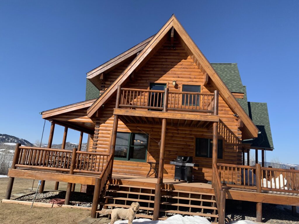 Log home staining in Jackson Hole - warm evenly absorbed stain across a full log elevation