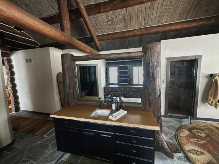 Bathroom remodel inside a log home with an exposed interior log post
