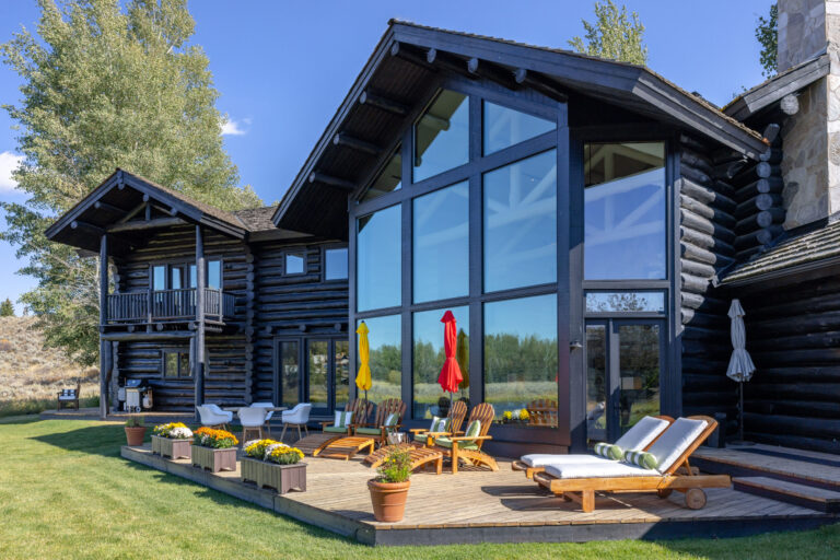 Dark-stained log home exterior in Jackson Hole restored and refinished by Log Care