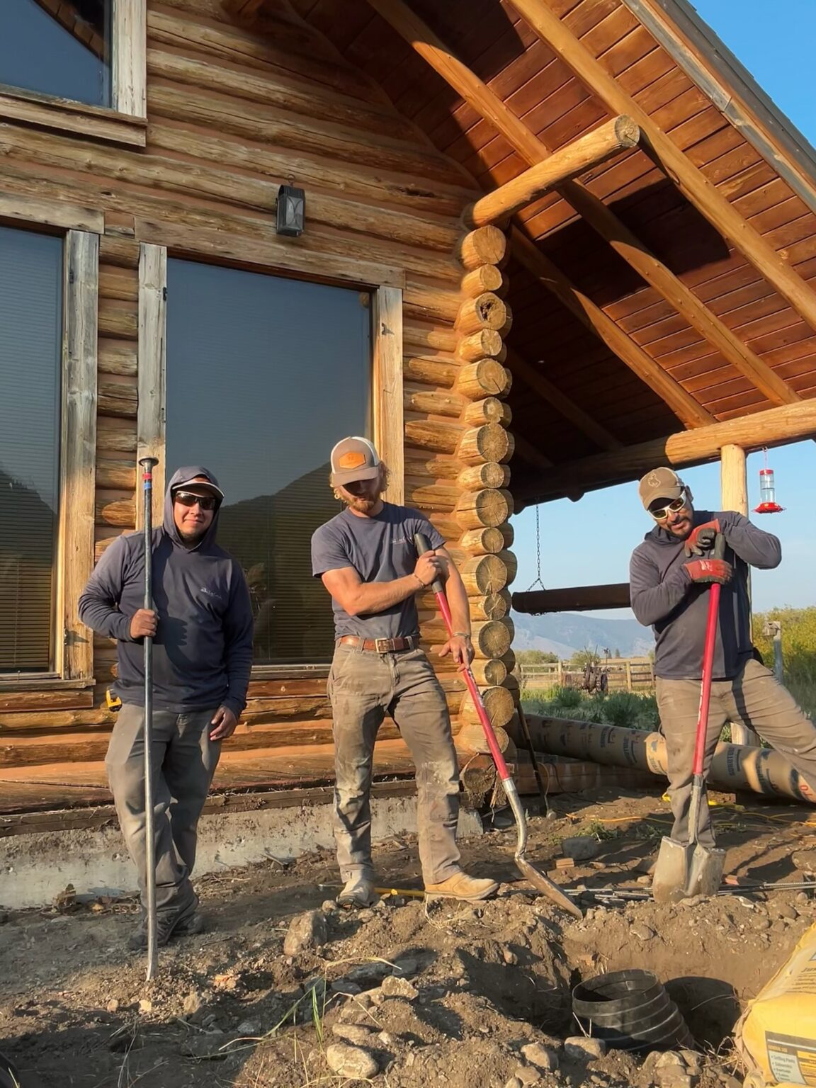 Log Care crew with cant hooks and a replacement log during log home repair in Teton County